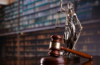 Gavel and statue in law library